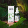 Frasco gotario y caja de la Infusión Herbal Doña Laly, extracto natural de la Línea Küme Felen de CDAN, rodeado de grandes hojas verdes.
