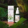 Frasco gotario y caja de la Infusión Herbal Doña Rosa, extracto natural de 4 plantas de la Línea Küme Felen, rodeado de hojas verdes.